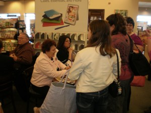 Mia, a new friend, and others wait to have their books signed by Mary